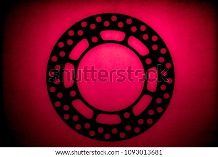 creative cover of sprocket silhouette and brake disk deep red back light