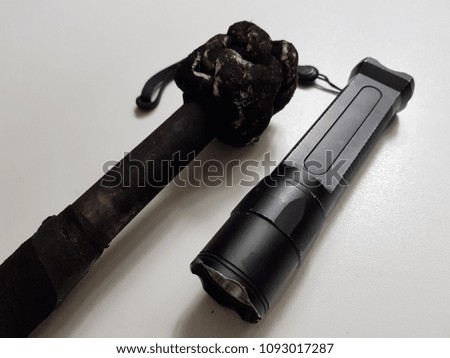 Black flashlight on torch of fire