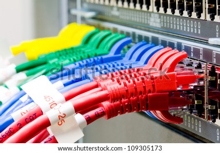 Network switch and UTP ethernet cables Royalty-Free Stock Photo #109305173