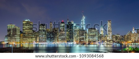 Scenic view at night of modern skyscrapers in lower Manhattan, New York City, USA. Concept for business, finance, real estate