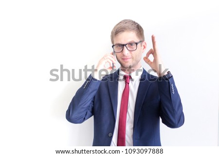 Successful, smilling businessman showing OK sign by his hands in the office. Satisfied with great development rate, business growth, company success concept.