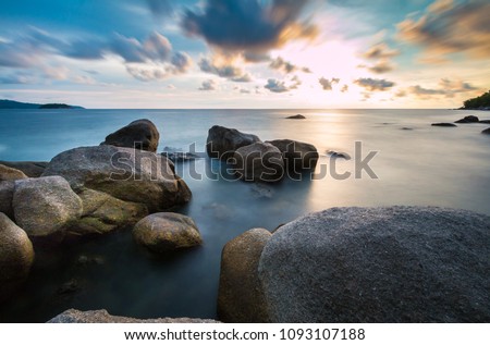 Long exposure shot.Beautiful sea scape with stone beach on a summer vacation,Motion blur,slow shutter speed.
