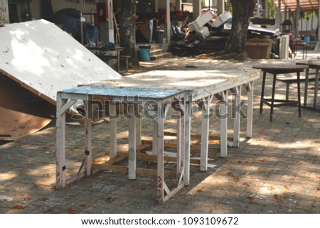Vintage Rustic Wooden Tables/ Chairs/ Stools Painted in Teal/ White Colors in Outdoor Garage/ Abandoned Studio Backyard/ JunkYard - Under the Tree in a Sunny Day 
