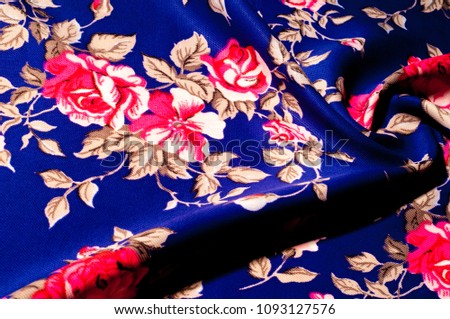 Background texture, pattern. Fabrics of blue color with painted roses, Polyester crepe. A clogged, textured surface with a dry hand feeling. Soft drapery. Suitable for design