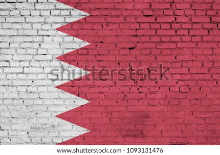 Bahrain flag is painted onto an old brick wall