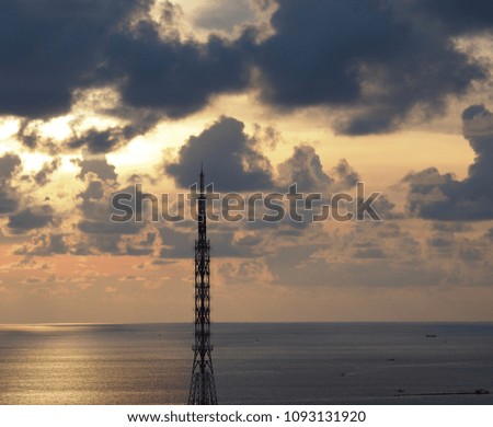 Sea sky and telephone signal tower in sunrise background