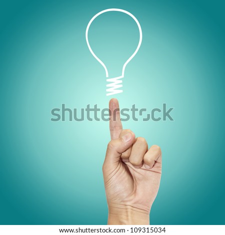 hand points to drawing light bulb Royalty-Free Stock Photo #109315034