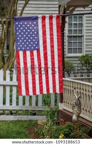 United states flag on historic home Royalty-Free Stock Photo #1093188653
