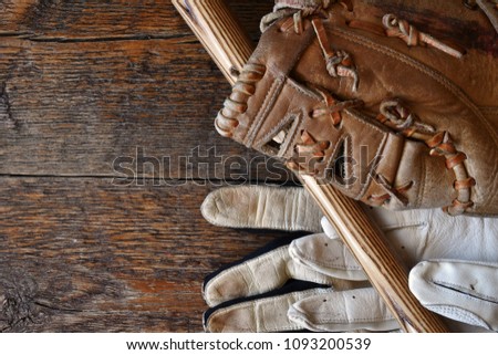 A close up image of old used baseball equipment. 