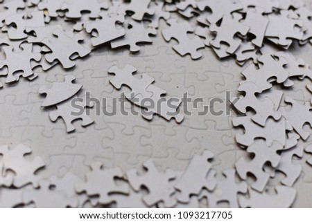 Gray puzzle piece on puzzle background.