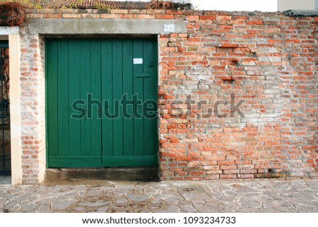 green door at the red brick fence, Venice Italy
