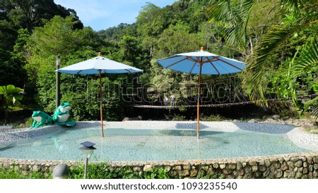 Hot mineral water pool in Raksa Warin public park at Ranong Province, Thailand. Royalty-Free Stock Photo #1093235540