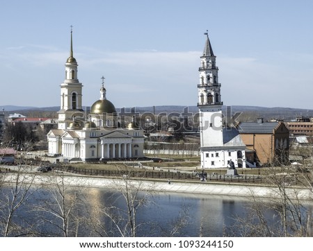 Spaso-Preobrazhensky Cathedral in the city and Nevyansk leaning tower. Famous Nevyansk Tower and Spaso-Preobrazhensky cathedral church bacground. Nevyansk leaning tower was built in 1732