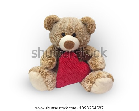 Soft toy teddy bear with heart in hands on isolated background