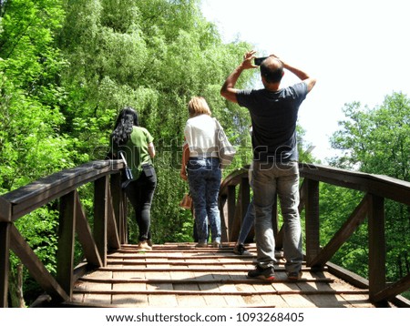 Tourists walk around the park and enjoy nature during the spring season and photograph certain parts of memory