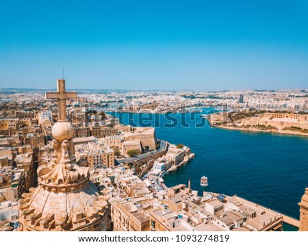 Aerial sunset view over Our Lady of Mount Carmel basilica. A domed cathedral that overlooks the ancient capital city of Valletta, Malta. Island country in the Mediterranean Sea.