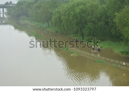 The bike path in the Han River was flooded by heavy rain.