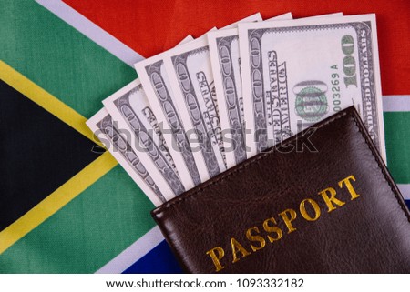 passport and money on the South Africa flag