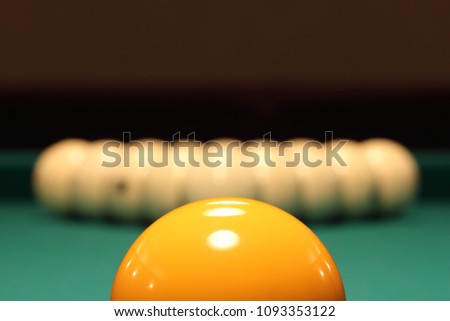 Macro view on billiard balls on the green table in dark lights.