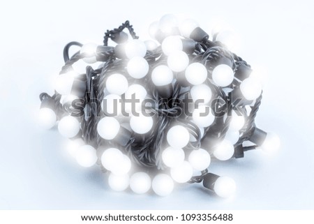 white bright lightened up Christmas lights in a white background