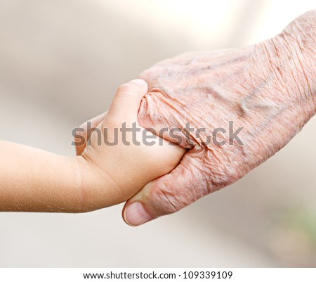 An old woman and a kid holding hands together Royalty-Free Stock Photo #109339109