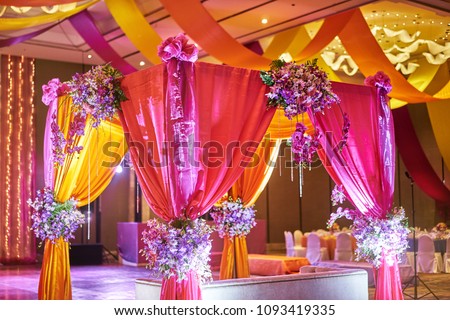 The colorful stage decoration with bright shade of color for bride and groom in the sangeet night of traditional indian wedding
