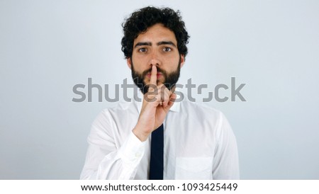 Handsome brunette man with shirt and tie asking for silence.
