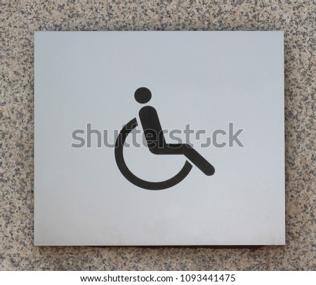 Wheelchair symbol on the wall background