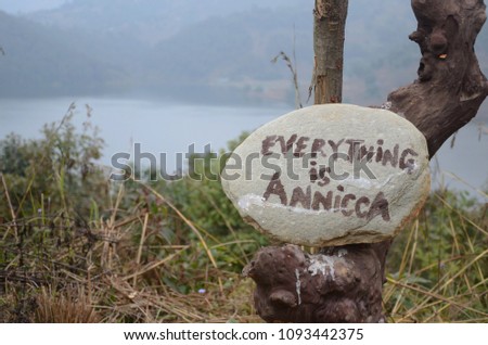A rock with the message of 'Everything is annicca". Annicca means impermanence in Pali language.