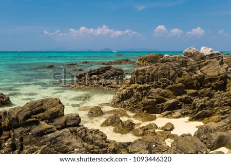 Ocean coast, tropical paradise -  turquoise ocean, rock on the white  sand,  islands on the horizon. View from shore of the tropical island. Bamboo Island ( Ko Phi Phi Don ) .Thailand. Seascape. 