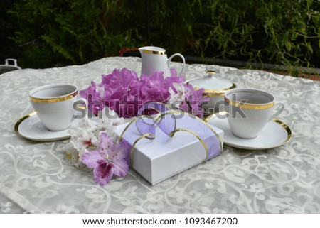 Coffee with a gift and flowers. 