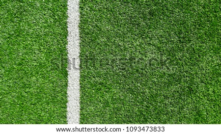 White stripe on the green soccer field from top view