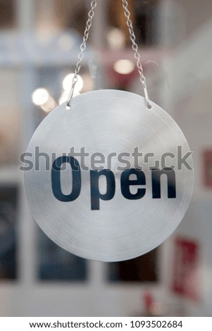 Silver Open Sign on Shop Door