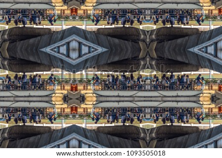 Abstract background pattern of urban life as a pedestrian - mirrored dark picture of a transport hub pedestrian bridge.