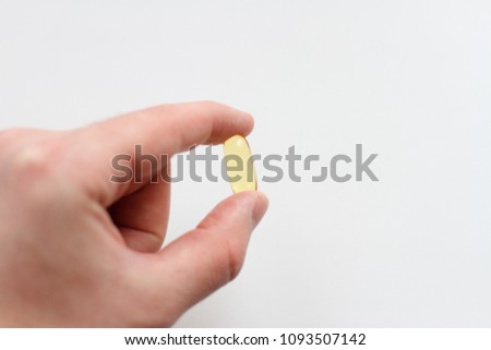 fish oil hold on hand white background