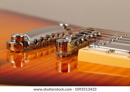 Old beautiful electric guitar on a background of wood.