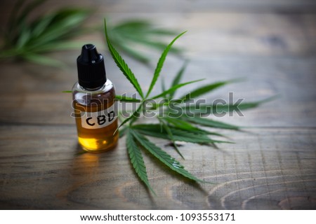 Medicinal cannabis with extract oil in a bottle Royalty-Free Stock Photo #1093553171