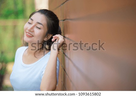 Portrait of beautiful asian chic girl pose for take a picture on brick wall,Lifestyle of teen thailand people,Modern woman happy concept