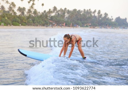 surfer girl surfing in the ocean