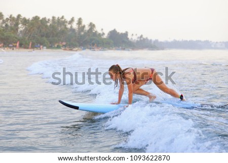surfer girl surfing in the ocean