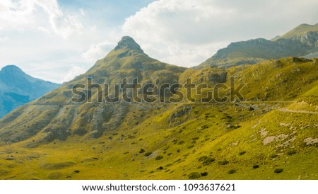 Montenegro, Durmitor national park, mountains and cloudy sky, road around a peak