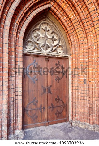 Old entrance wooden doors with forged handles of the Catholic Church, Latvia, Europe