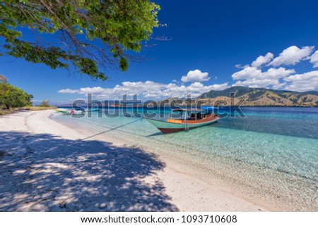 Boats on the beach on an island in the Seventeen Island National Park, Flores, Indonesia.  Royalty-Free Stock Photo #1093710608