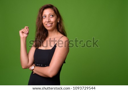 Studio shot of beautiful woman against chroma key with green background
