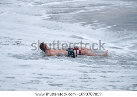 unknown man is relaxing on the beach