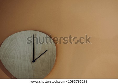 modern design clock on light concrete wall , business time concept : late appointment, late morning, wake up late, buyer can add text on the top of clock and right side of the picture
