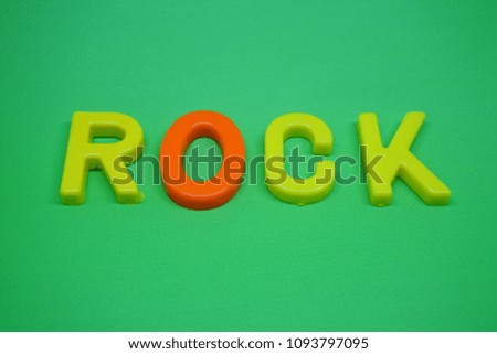 letters of rock music genre on green background
