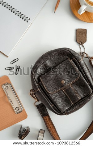 Traveler accessories, leather bag, coffee cup, notepad, camera  and passport on white background with copy space.Travel vacation concept. Flat lay, top view.