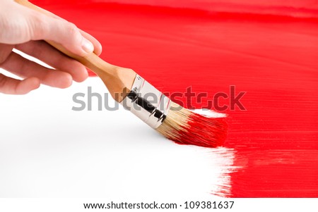 Painting with red colored ink and brush on white