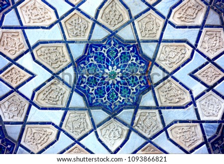 Photo of an ancient beautiful Oriental ornament on the wall